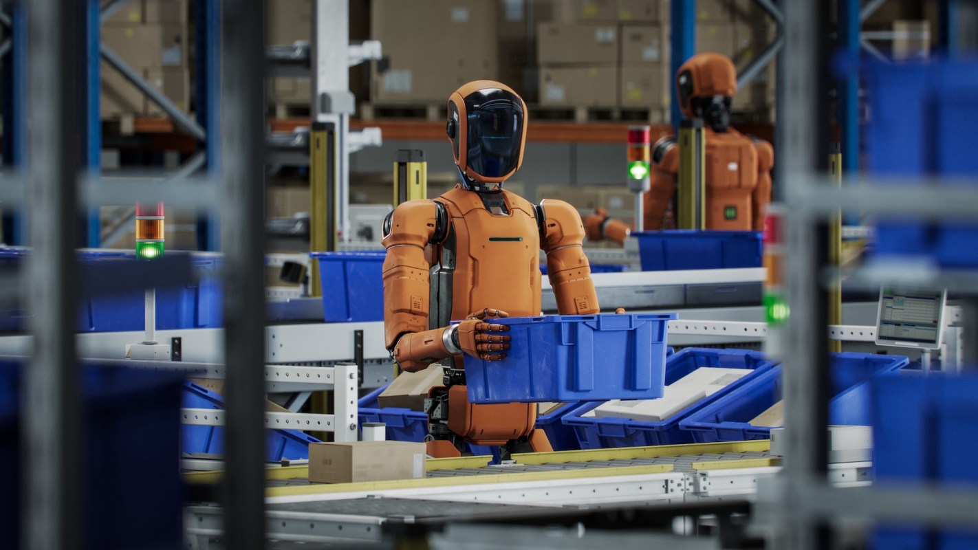 A robotics workspace with orange robots handling blue containers on conveyor belts.