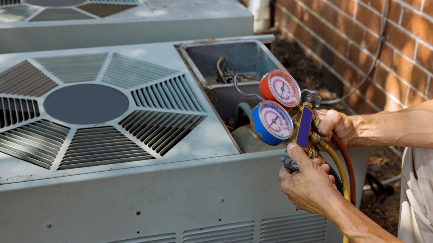 A technician servicing an AC unit.