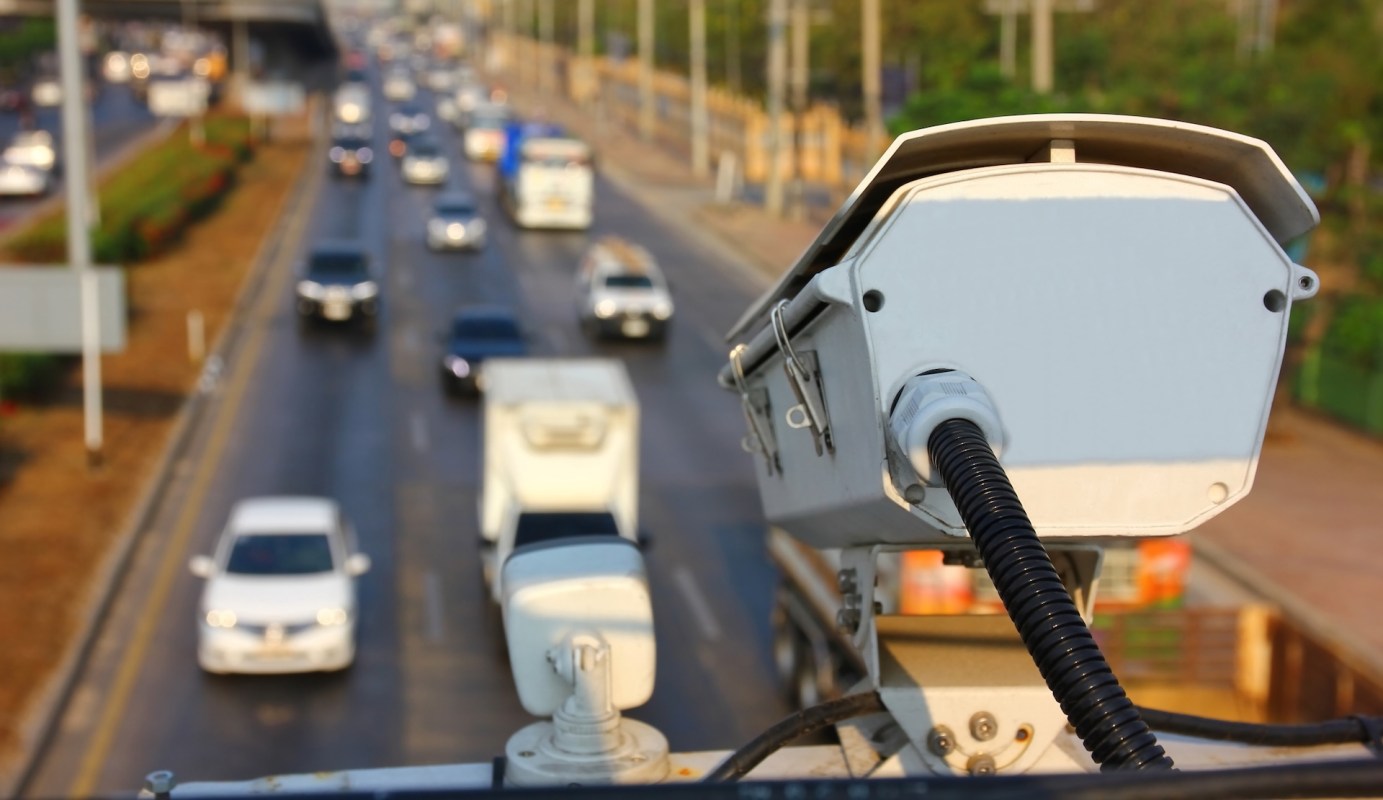 A surveillance camera over a highway.