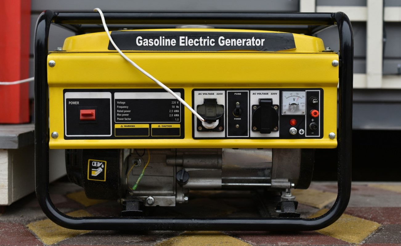 A gasoline electric generator with control panel and power connections.