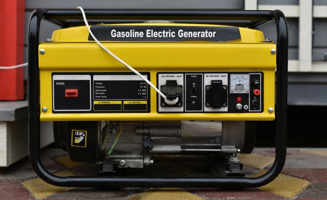 A gasoline electric generator with control panel and power connections.