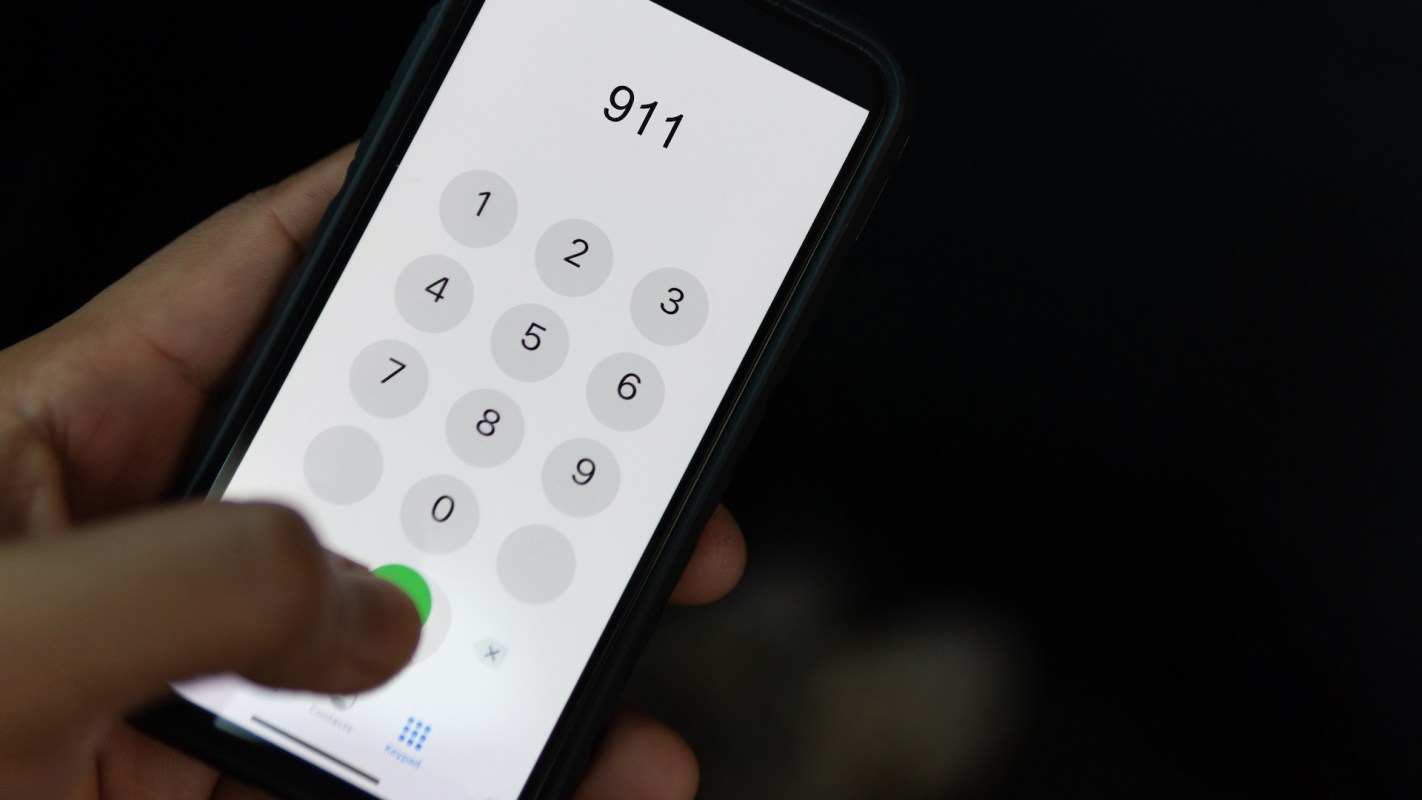 A person dialing 911.