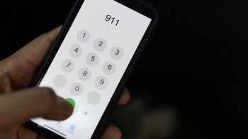 A person dialing 911.