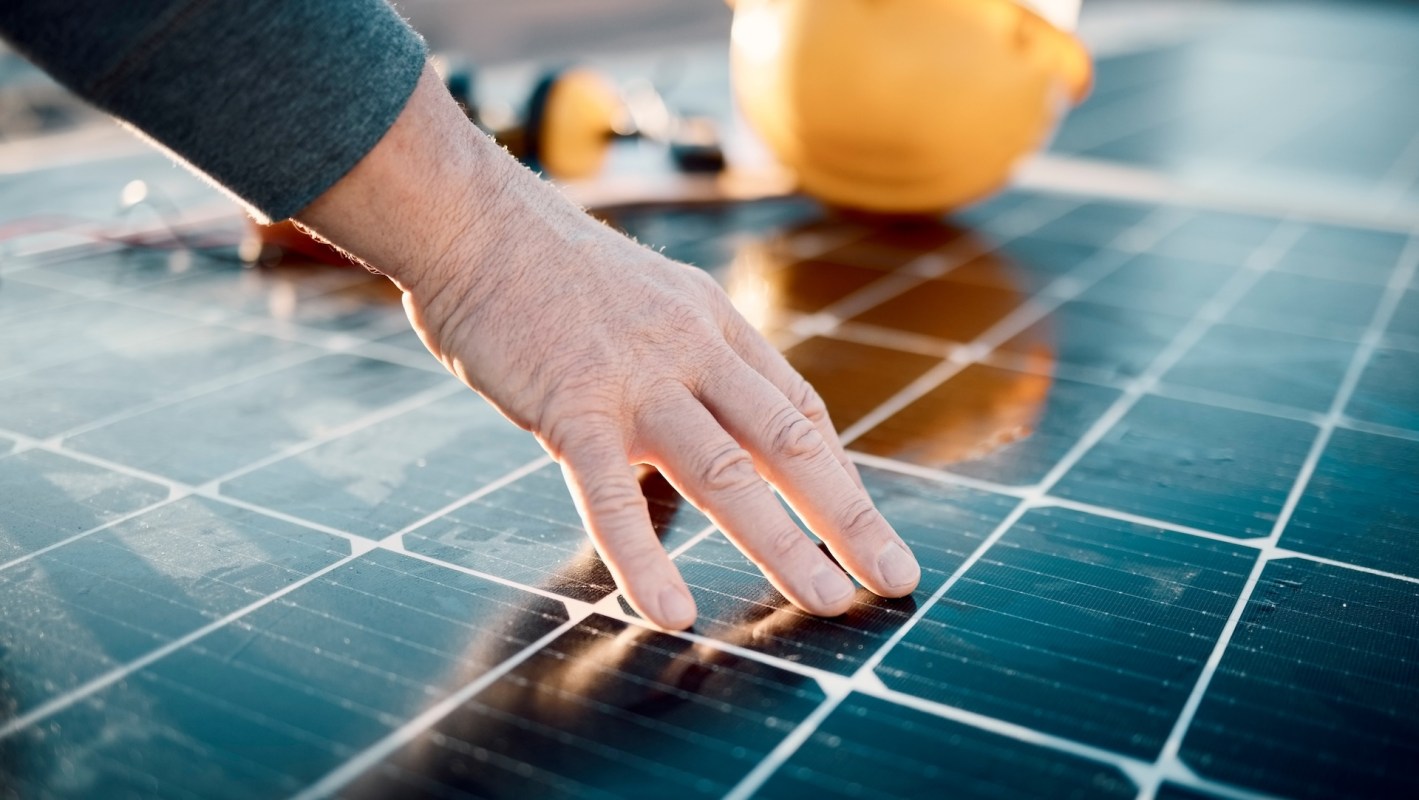 A technician inspecting a solar panel.