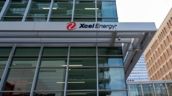A building with large glass windows featuring the Xcel Energy logo.