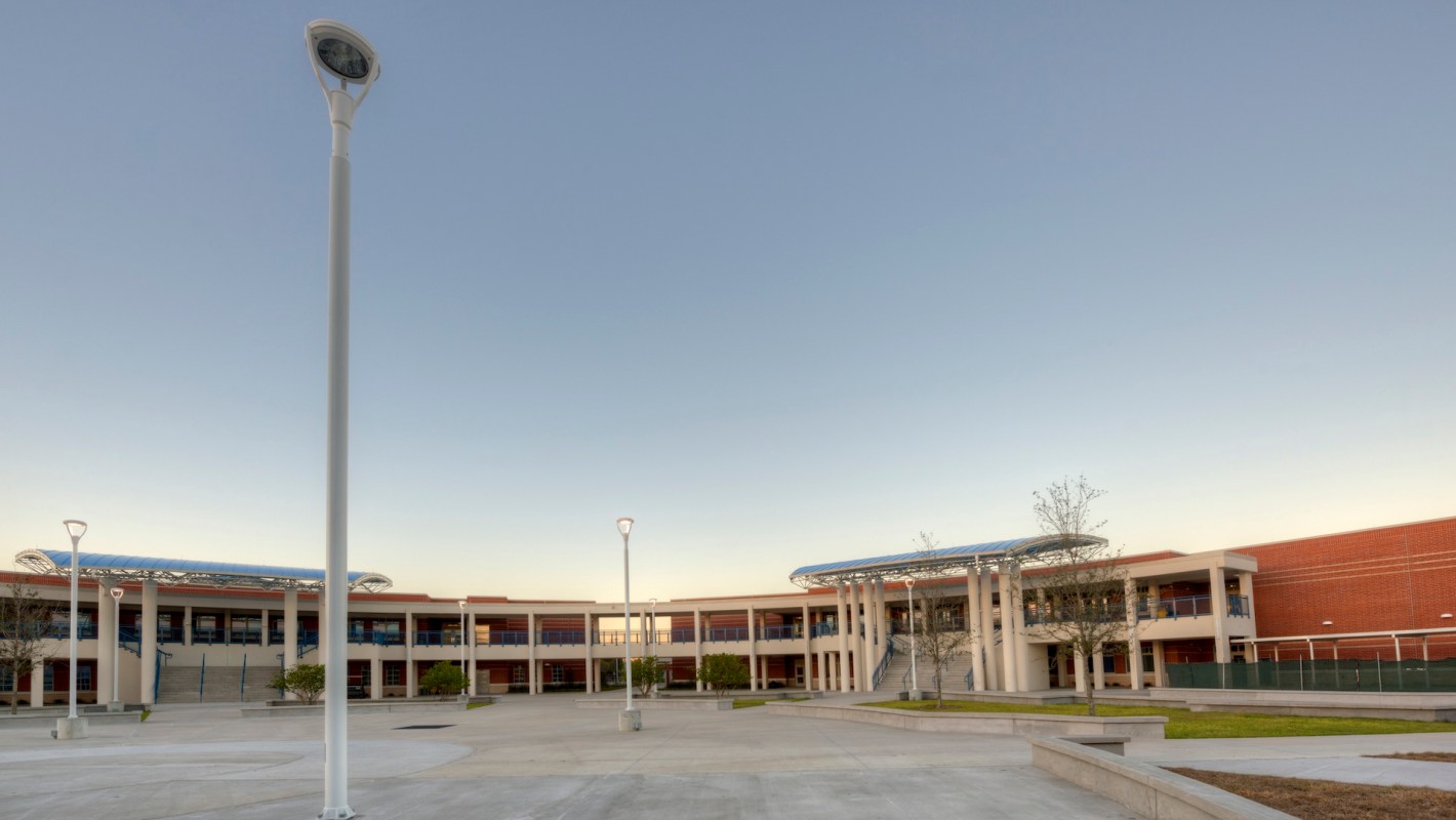 A modern school building with an open courtyard and light fixtures.