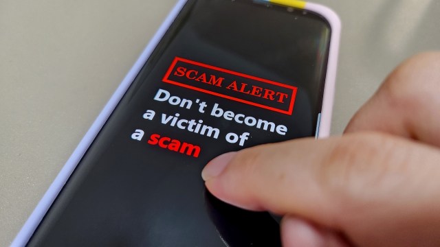 A phone with a scam alert.