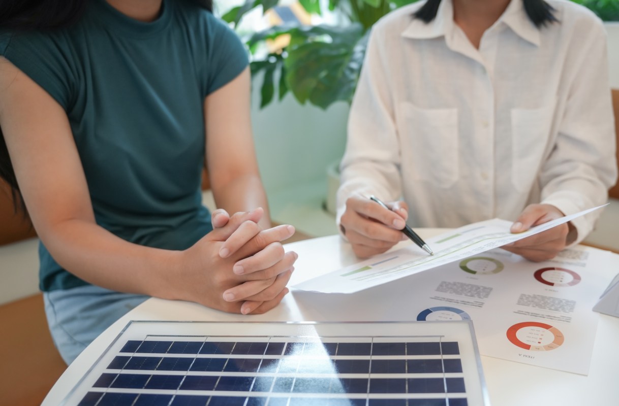 Two people discussing solar panel options.