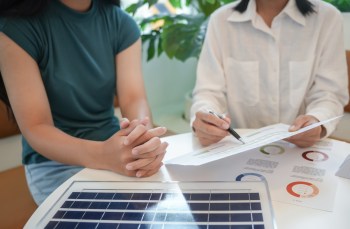 Two people discussing solar panel options.