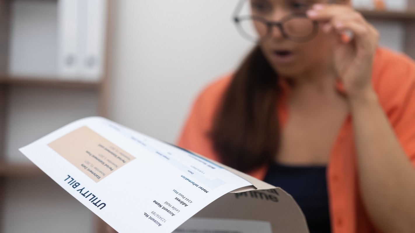 A person reading a utility bill.