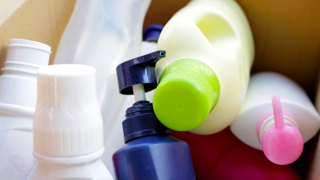 A collection of plastic bottles and containers in a cardboard box.