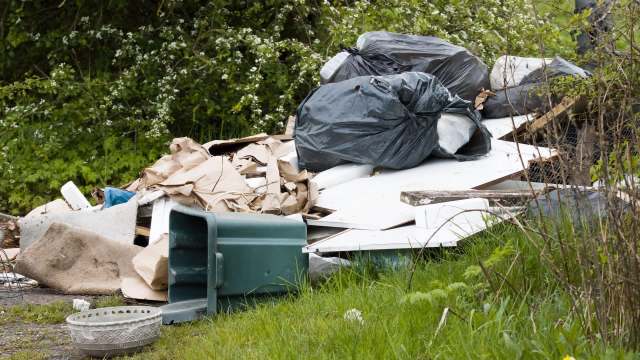 A pile of garbage in the countryside.