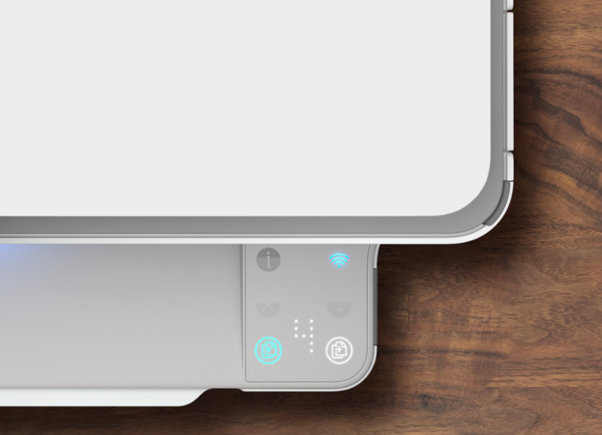 A device with control buttons and indicators on a wooden surface.