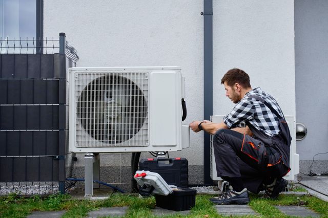 A technician installing a heat pump.