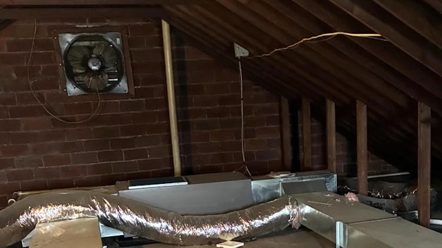 An unfinished attic with exposed ductwork.
