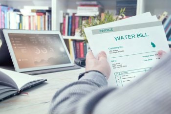 A person reviewing a water bill.