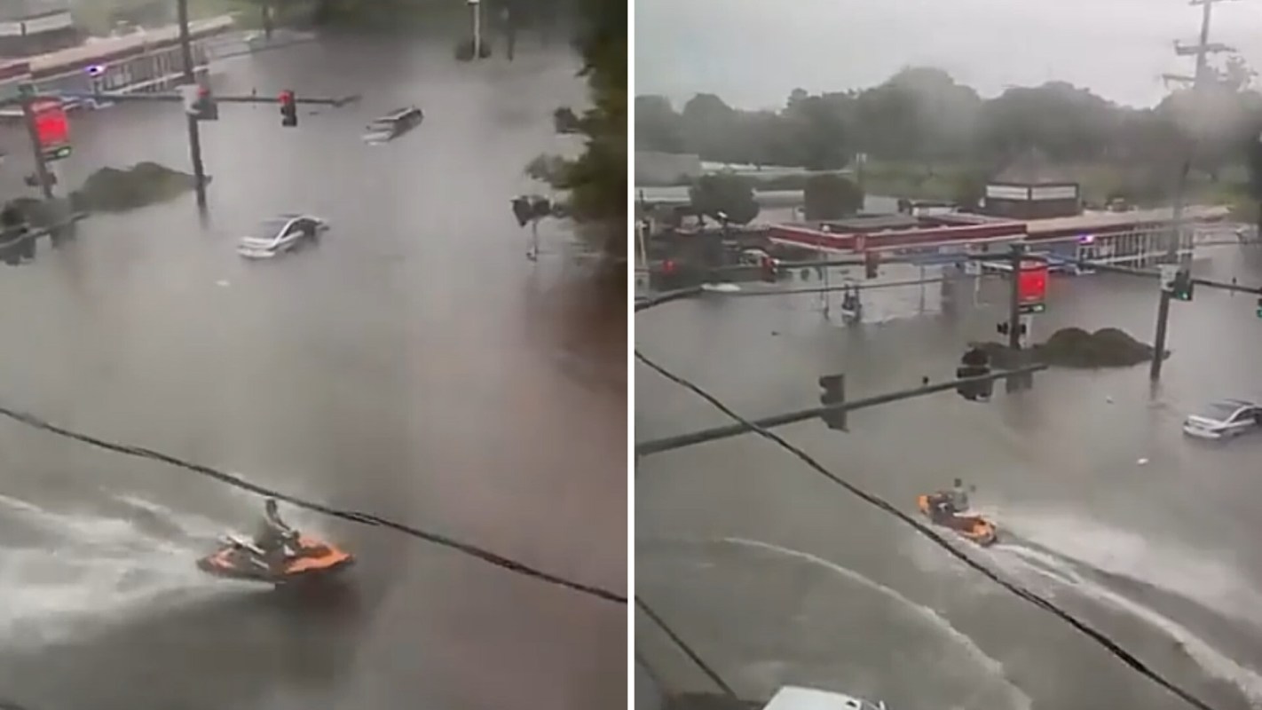 A jet ski navigating through flooded roads.