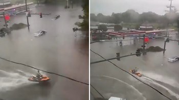 A jet ski navigating through flooded roads.