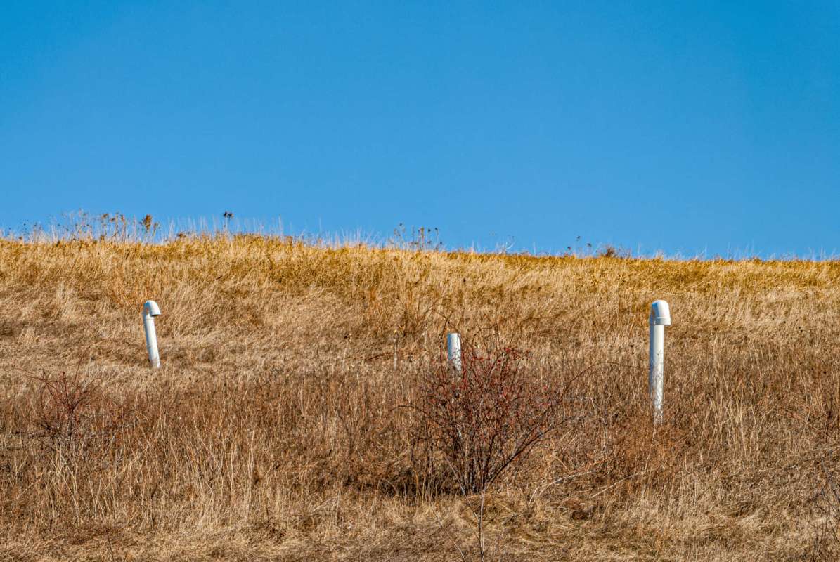 Exhaust pipes on a dry hillside.