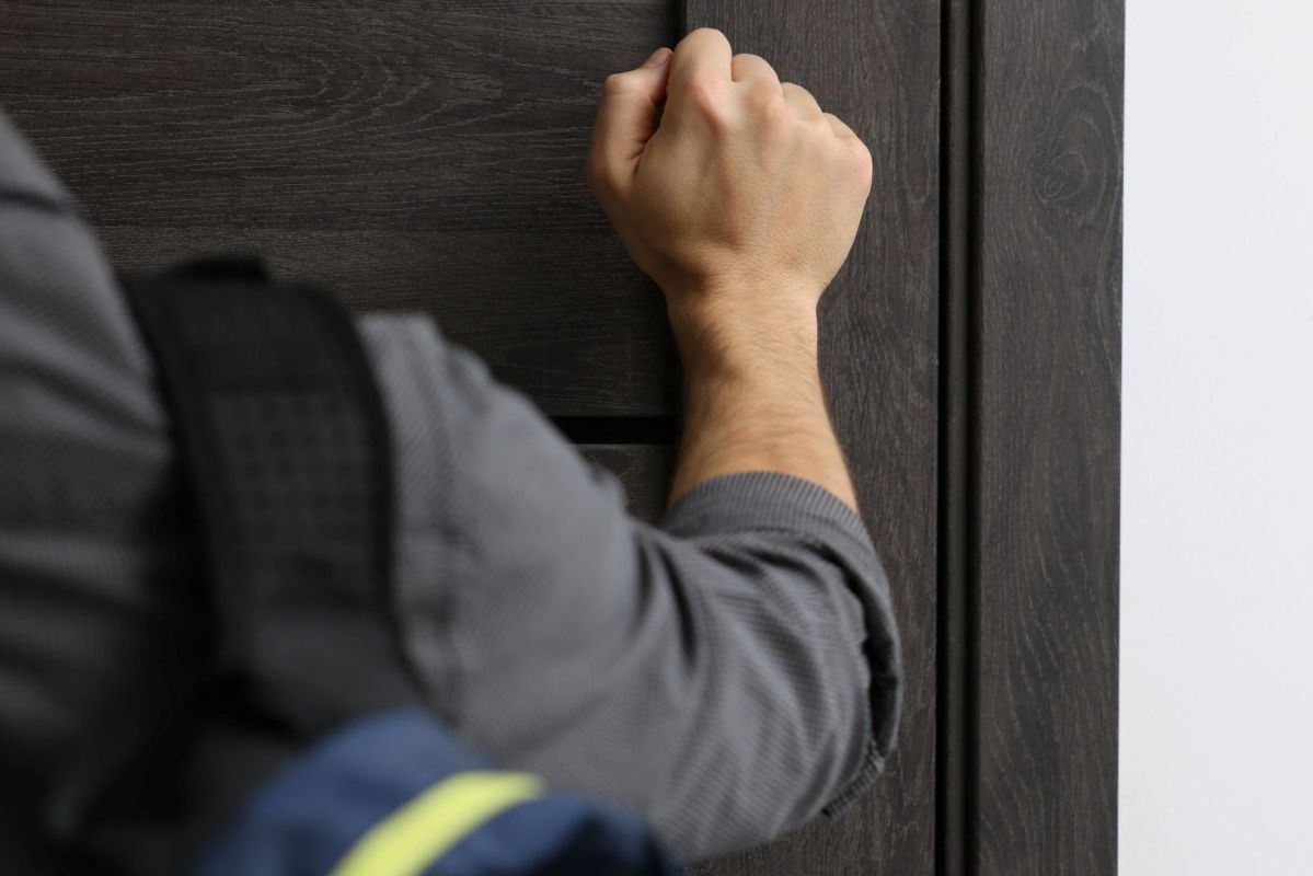A man knocking on a door.