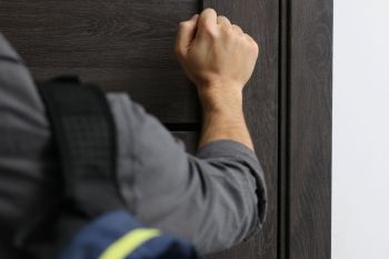 A man knocking on a door.