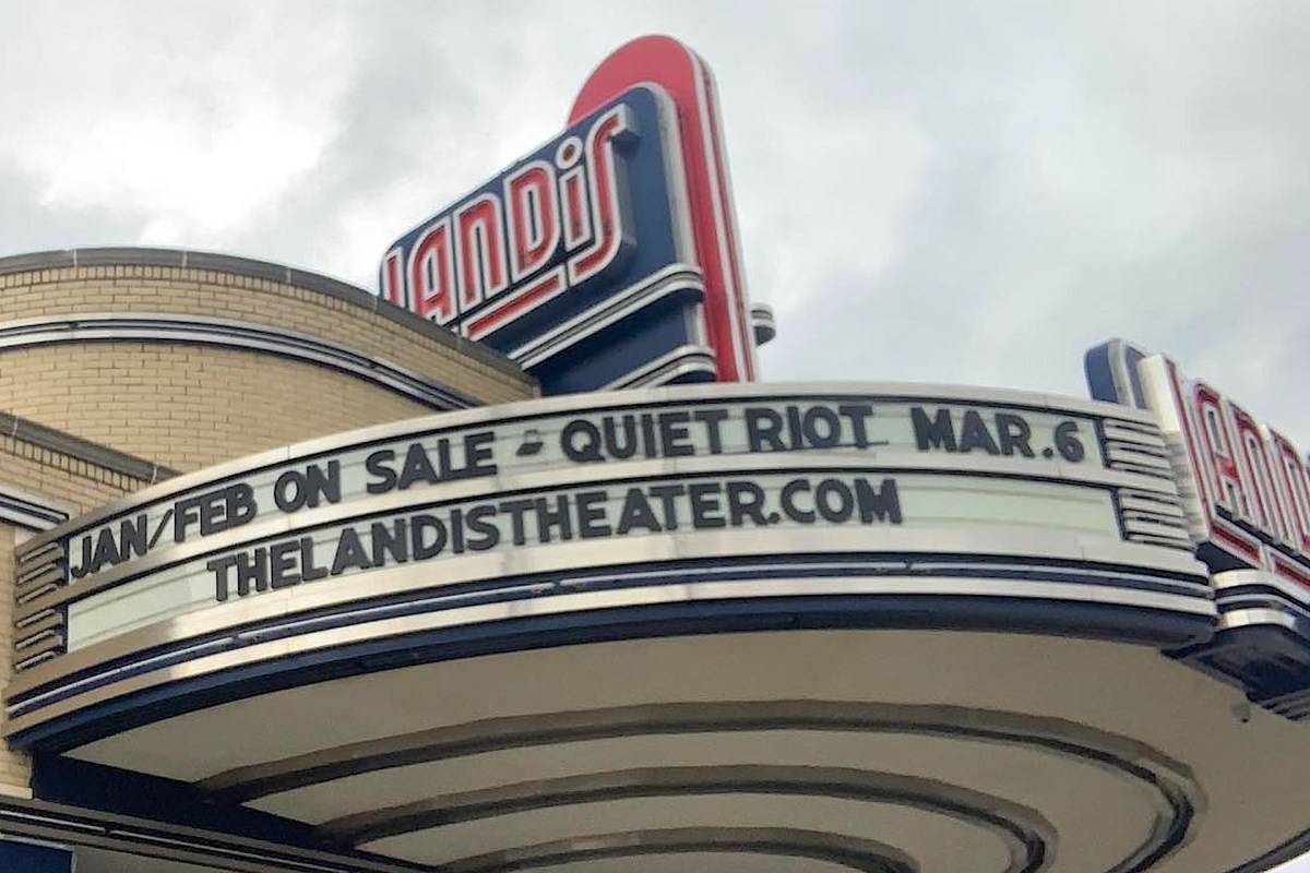 The marquee of a theater announces upcoming shows, including "Quiet Riot" on March 6.