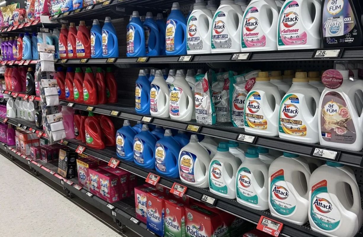 Liquid laundry detergent on grocery store shelves.