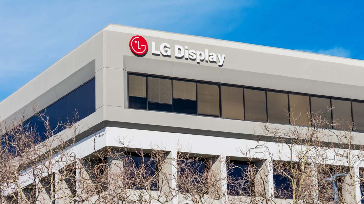 A modern building with a sign displaying "LG Display" and large windows.