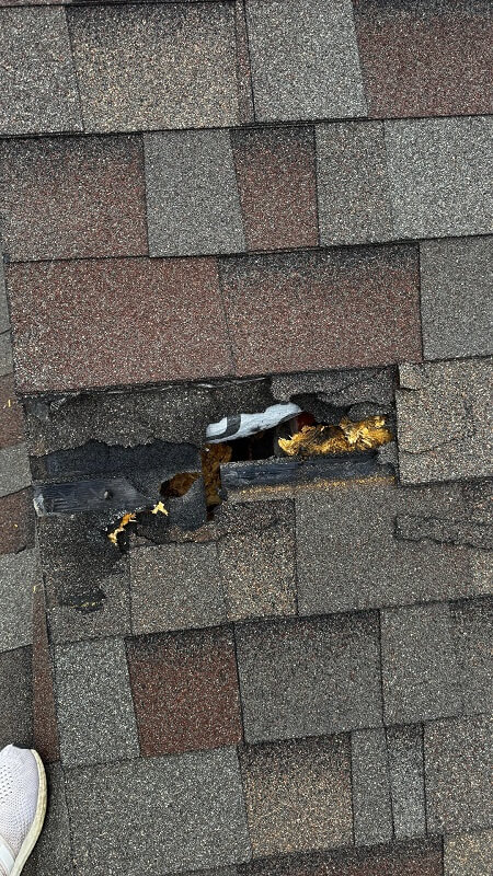 A torn hole in a roof.
