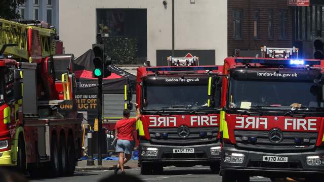 Three fire trucks parked on the street.