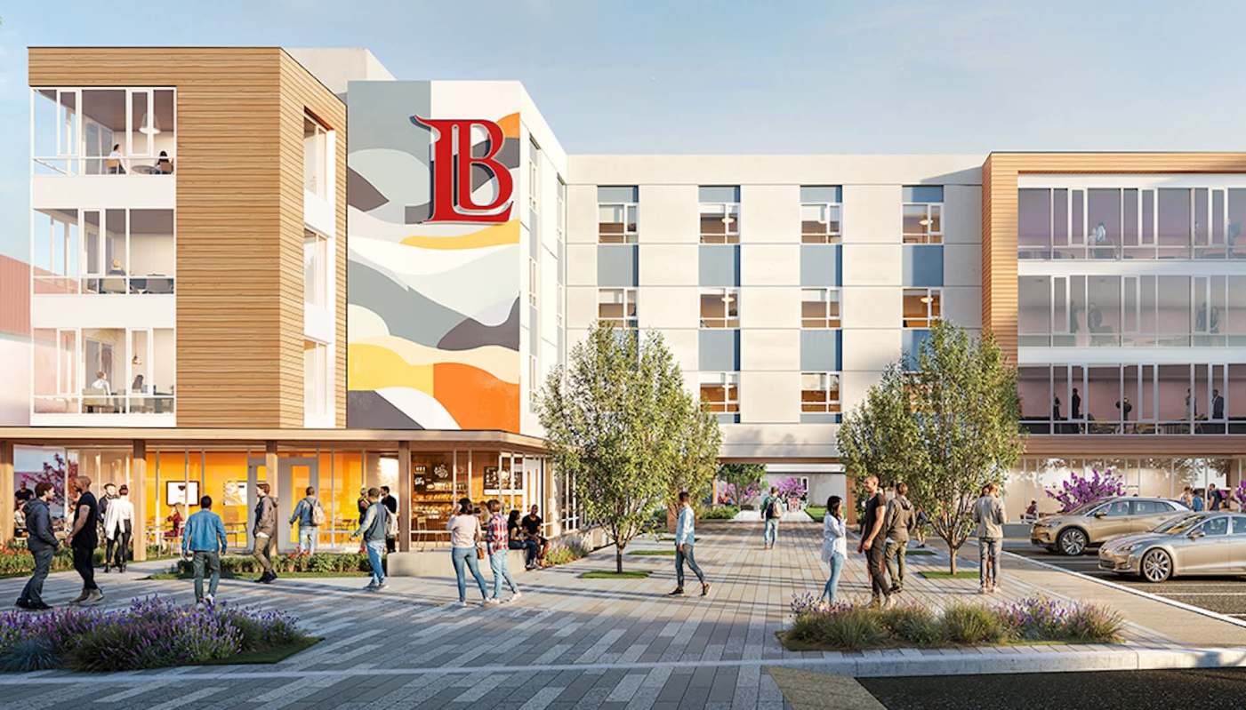 A modern building with a colorful mural, surrounded by people and landscaped areas.