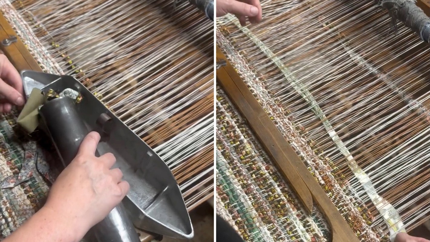 A person is using a weaving tool on a loom with colorful threads.