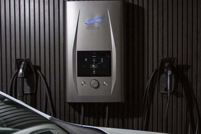 An electric vehicle charger on a wall.