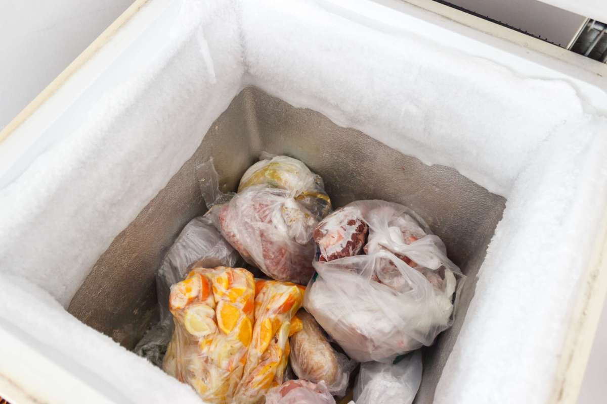Meat and fruit in a freezer.