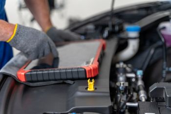 A mechanic looking at an EV.