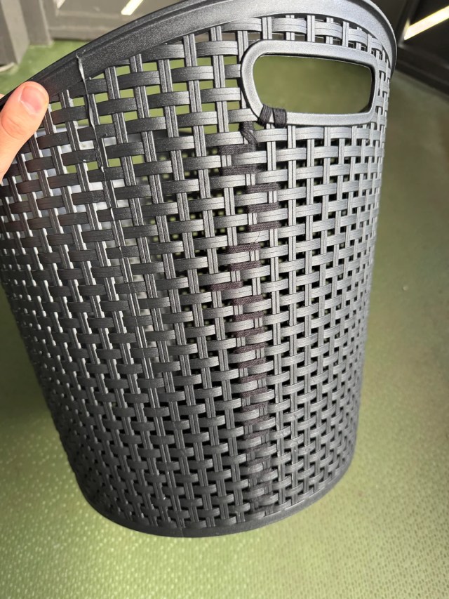 A split basket tied together with yarn.