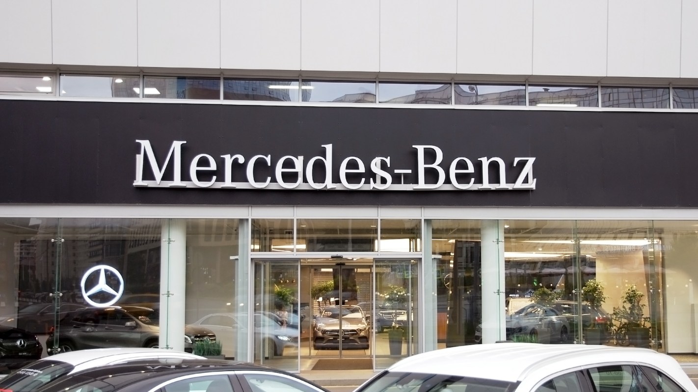 A Mercedes-Benz dealership with the brand logo displayed prominently on the building.