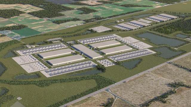 An aerial view of a data center complex surrounded by fields and greenery.