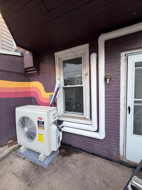 A mini-split installed by a window.