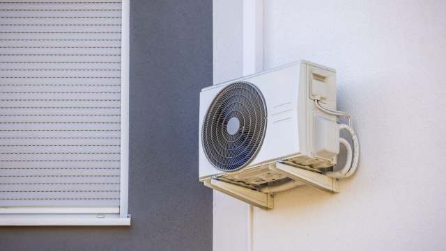 An AC unit mounted on a wall.