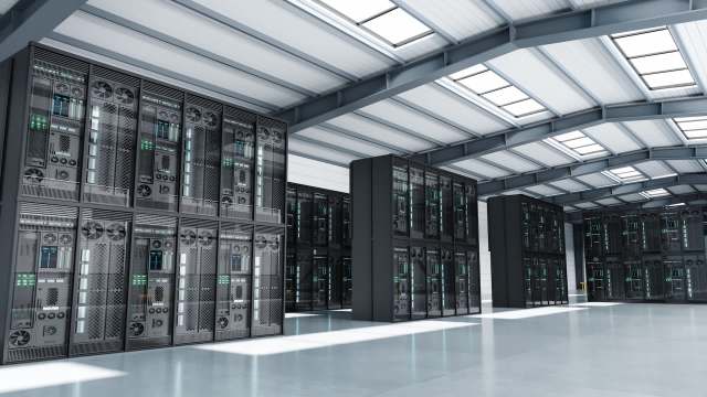 A data center featuring rows of server racks in a spacious, modern facility.