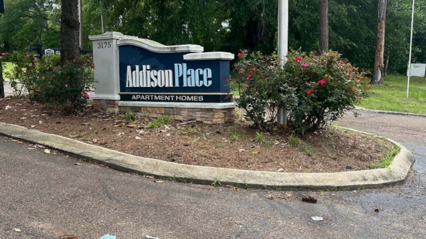A sign for Addison Place Apartment Homes.