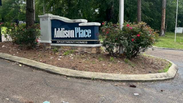 A sign for Addison Place Apartment Homes.