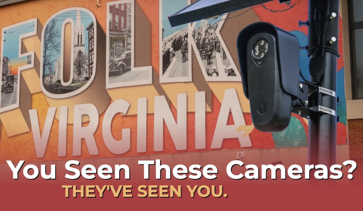 A security camera mounted next to a colorful mural that includes the word "Virginia."