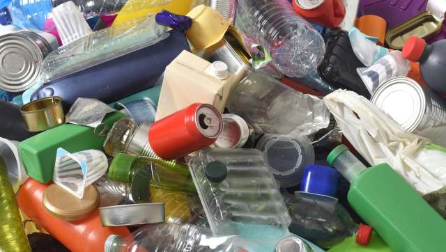 A pile of assorted plastic and metal containers, including bottles, cans, and packaging materials.