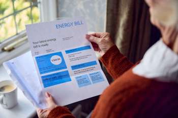 A person looking at an energy bill.