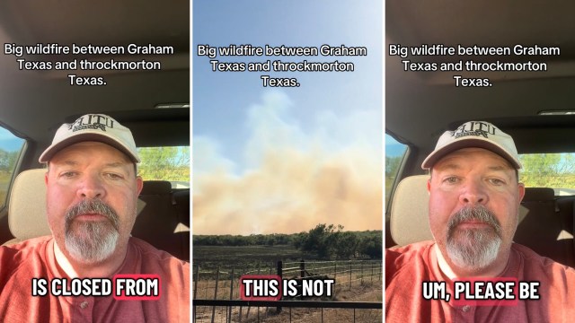 A man speaks from his vehicle about a wildfire between Graham and Throckmorton, Texas, with smoke visible in the background.