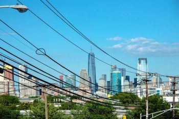 The New York City skyline behind power lines.