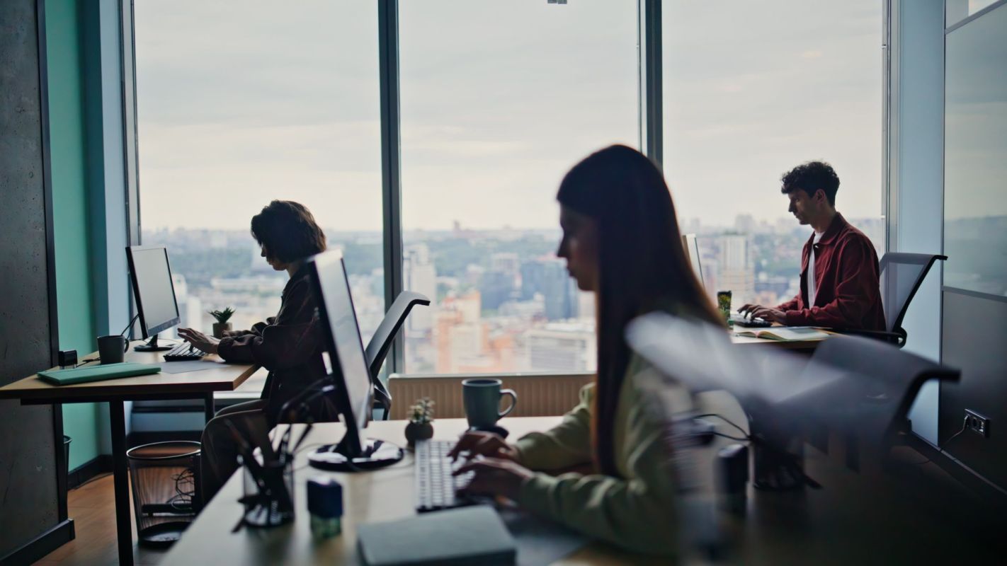 Employees working at desks in an office.