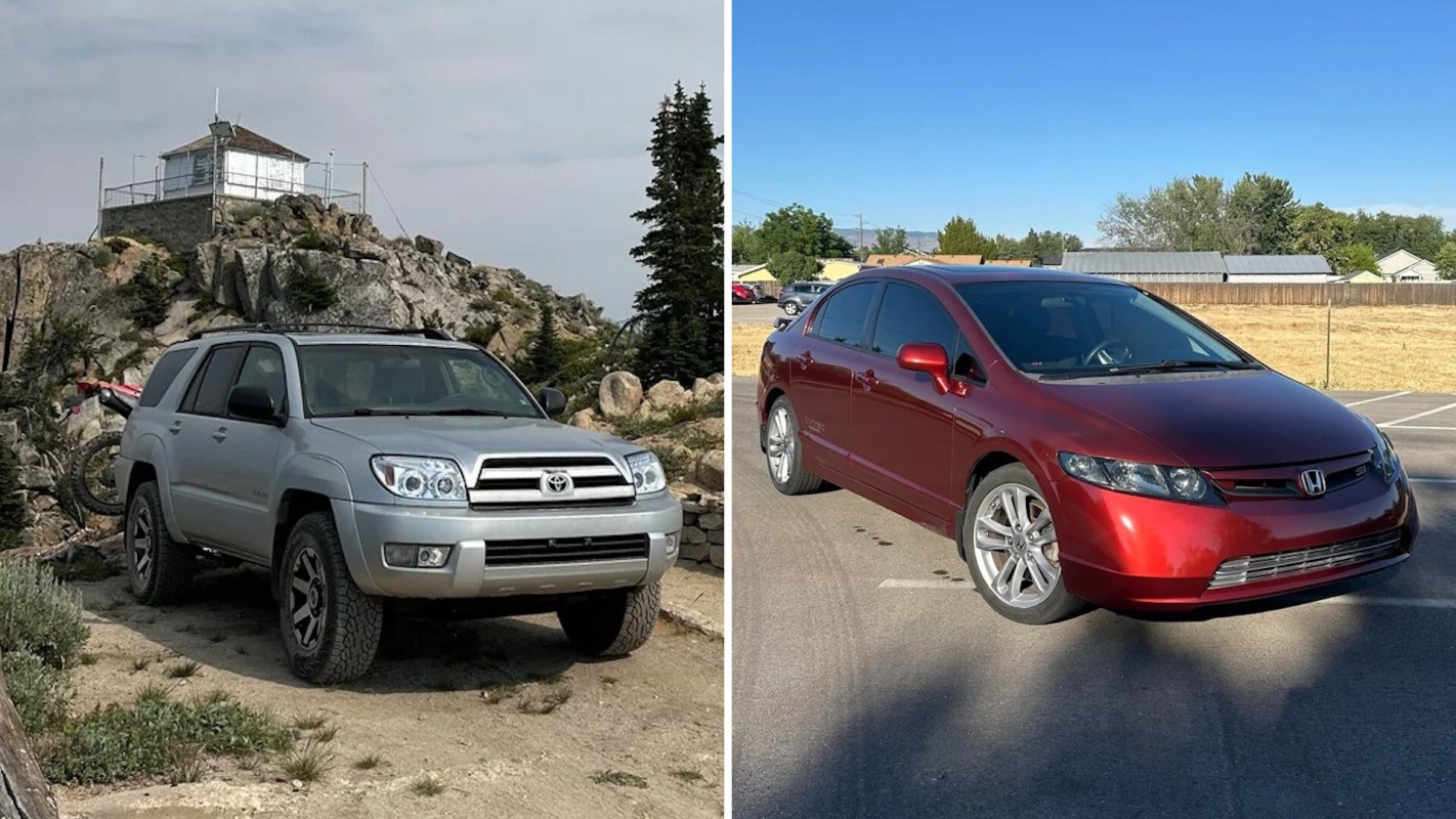 A silver SUV parked near a rocky outcrop and a red sedan on a pavement on a clear day.